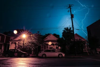 Lightning striking in a residential neighborhood in need of emergency electrical repair.